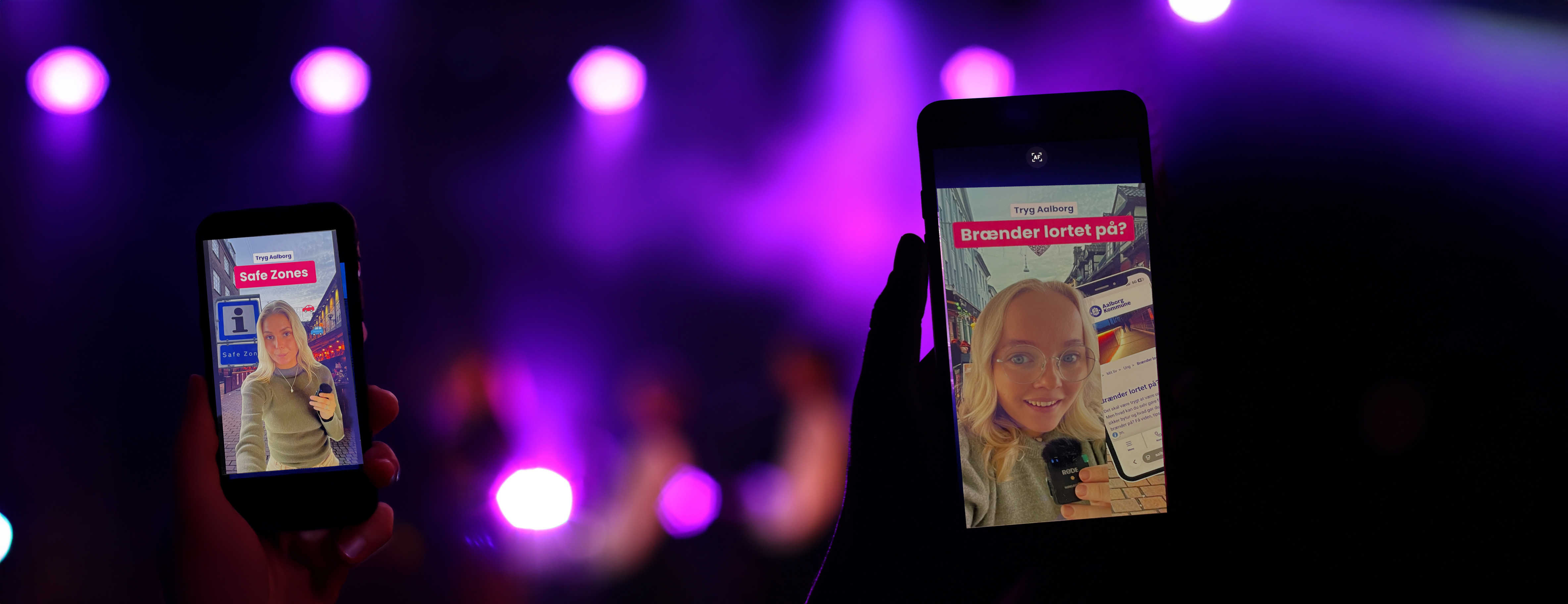 To personer i nattelivet, der ser video på deres telefoner om Safezones og Nødinfo.