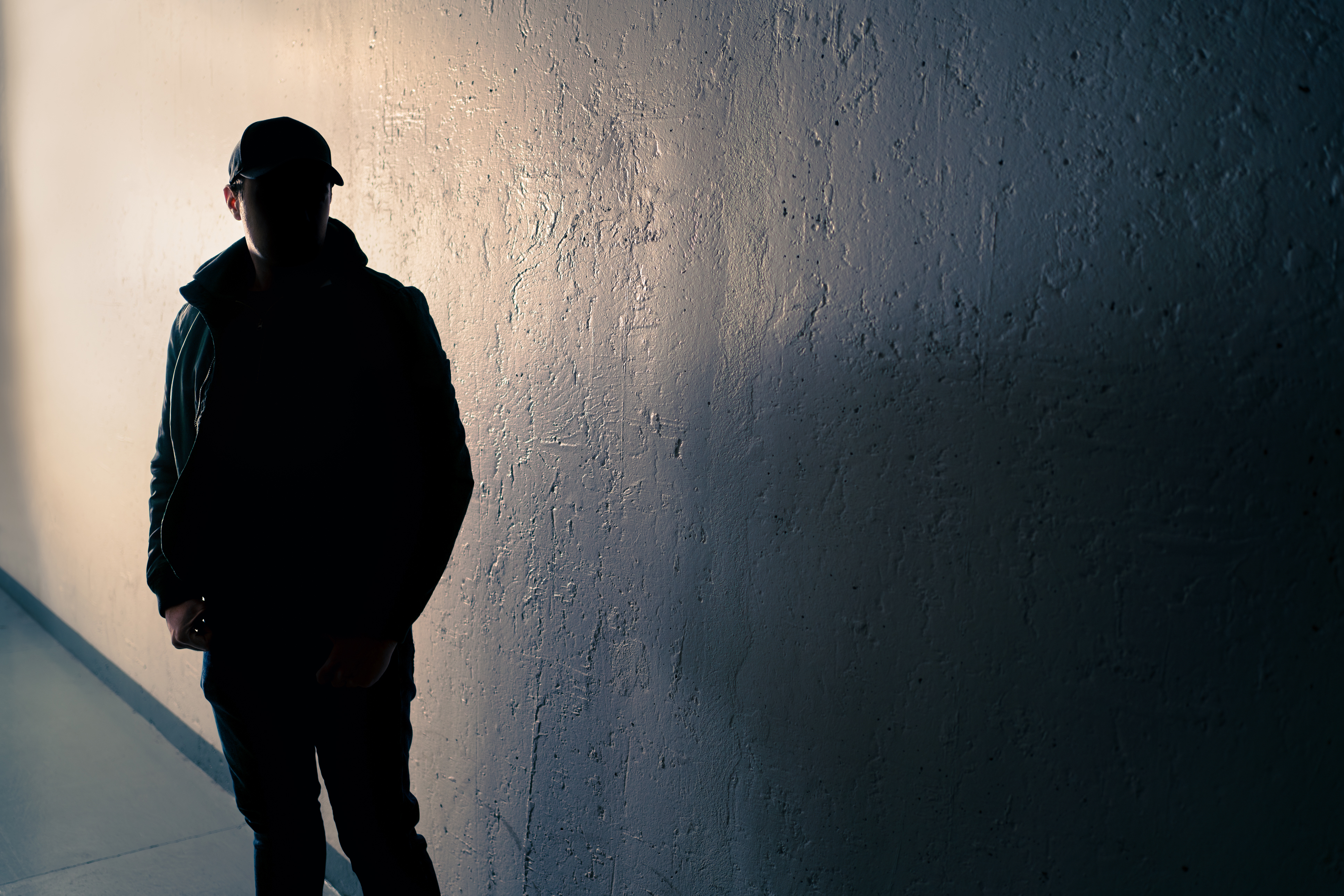 Person med ryggen mod muren