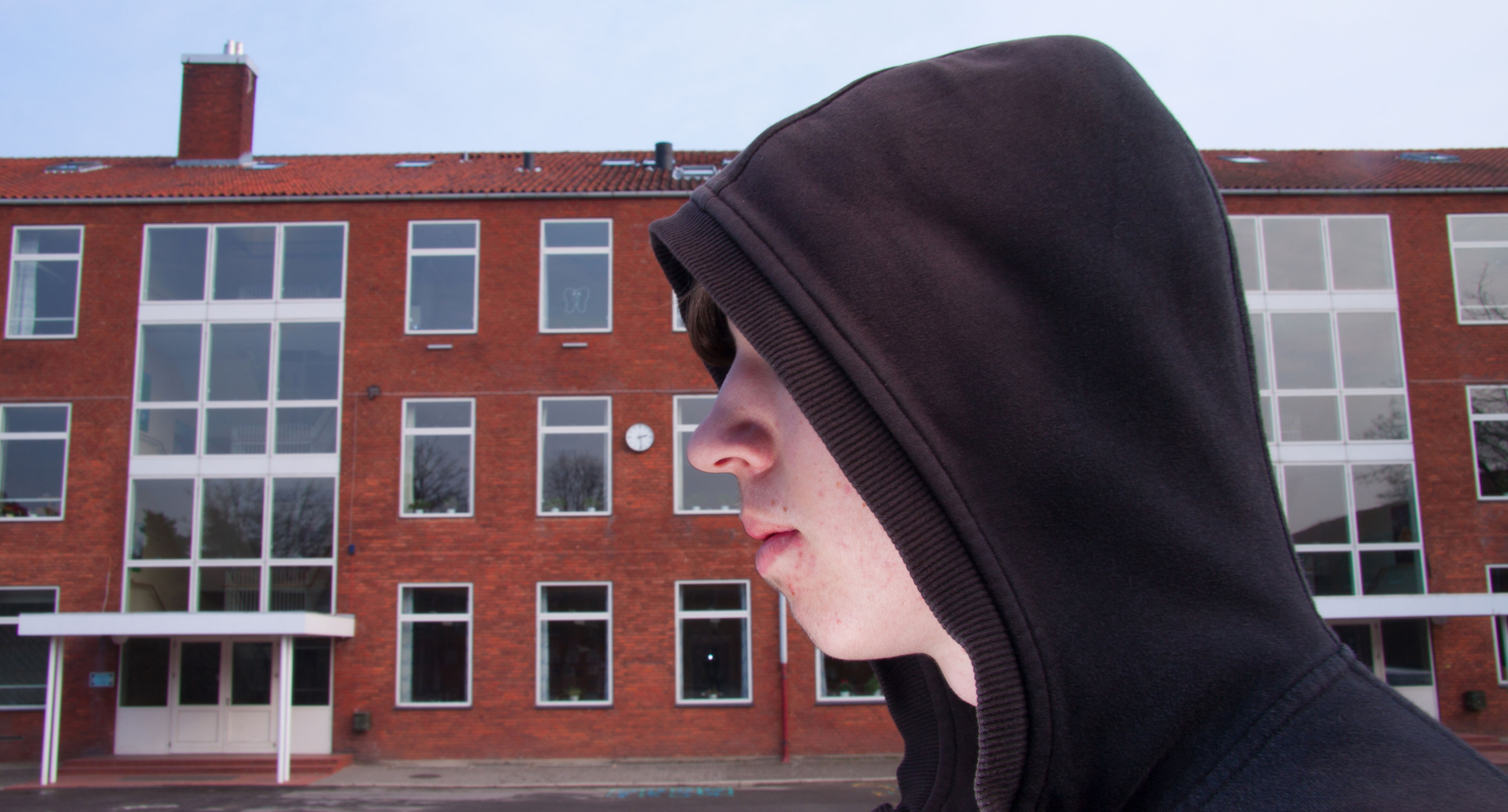 Ung Mand Med Hætte På, Fotograferet Fra Siden